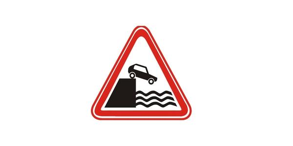 Image: upward-pointing red-edged triangle showing a black car descending from a ledge toward three rows of wavy water lines.