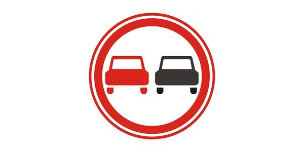 Image: white circle with a broad red rim and thin inner ring containing two front-facing passenger cars, red on the left and black on the right.